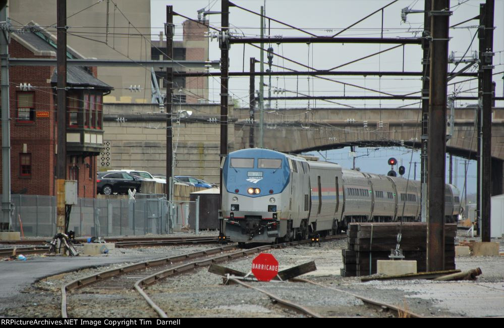 AMTK 117 on train 42 passes Harris tower